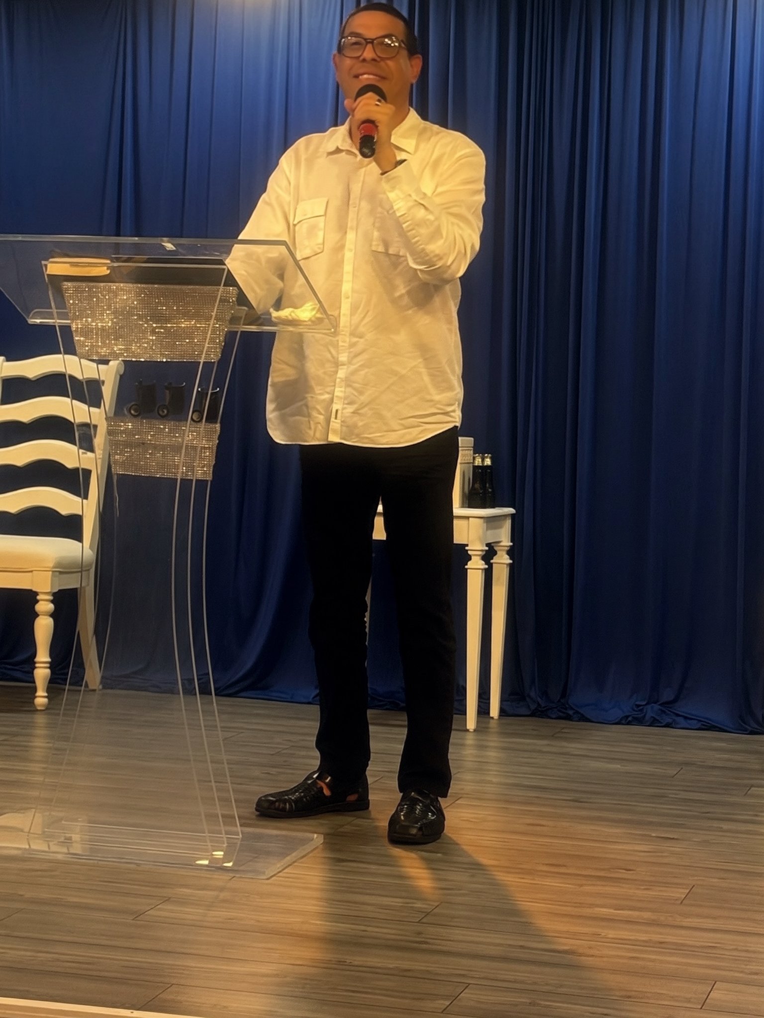 Pastor Carlos A. Morales preaching at the pulpit